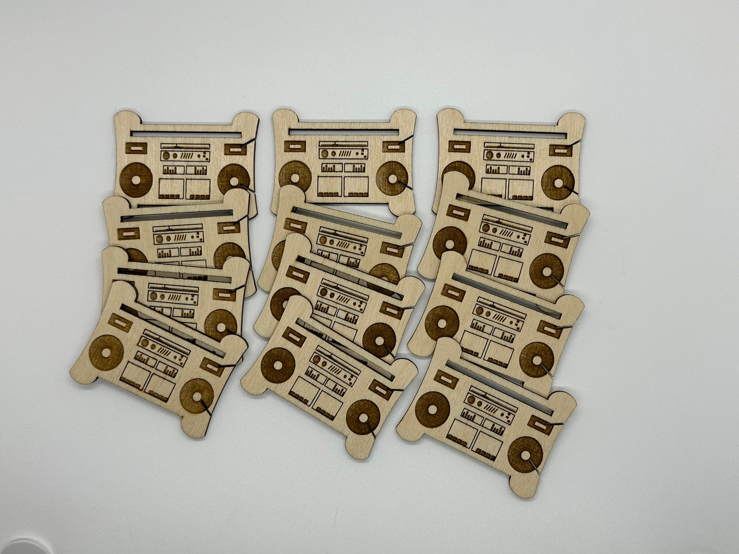 Set of wooden bobbins with radio and cassette design on a white background