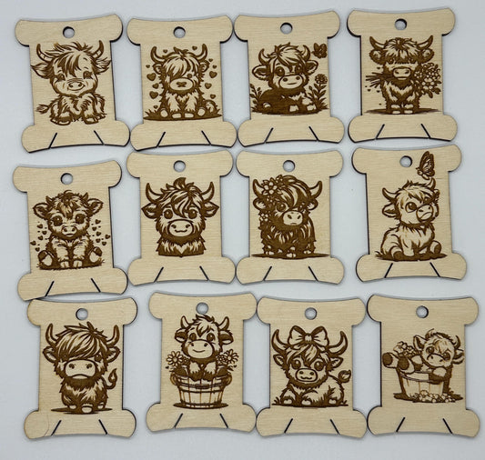 Set of wooden tags with engraved cow designs on a white background