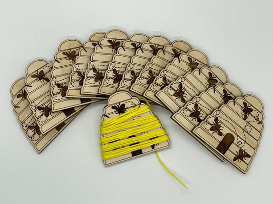 Set of wooden bee hive with a yellow thread on a white background