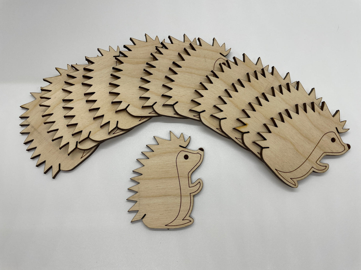 Wooden hedgehog cutout on a light gray background