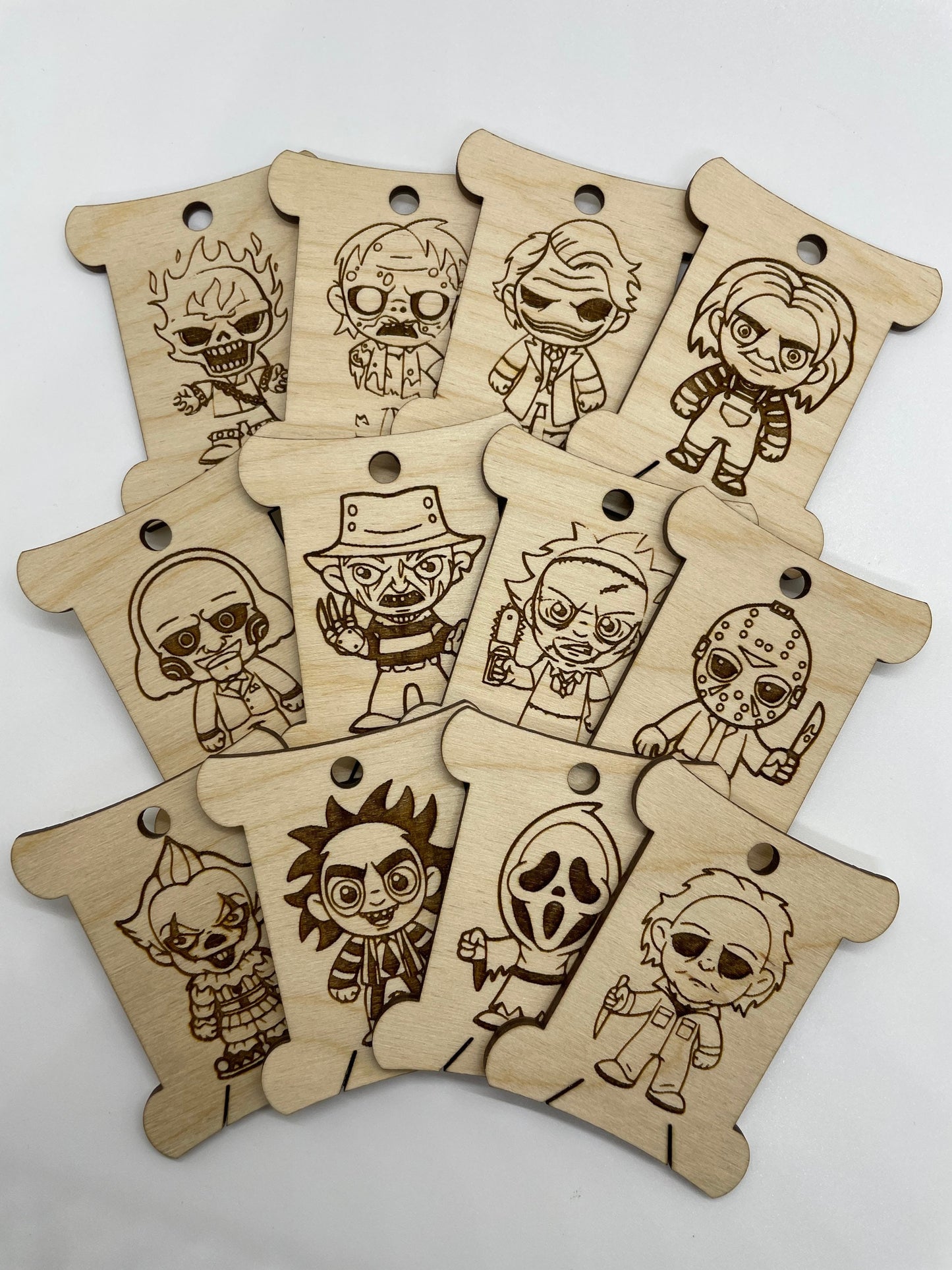 Set of wooden tags with engraved cartoon character designs on a white background