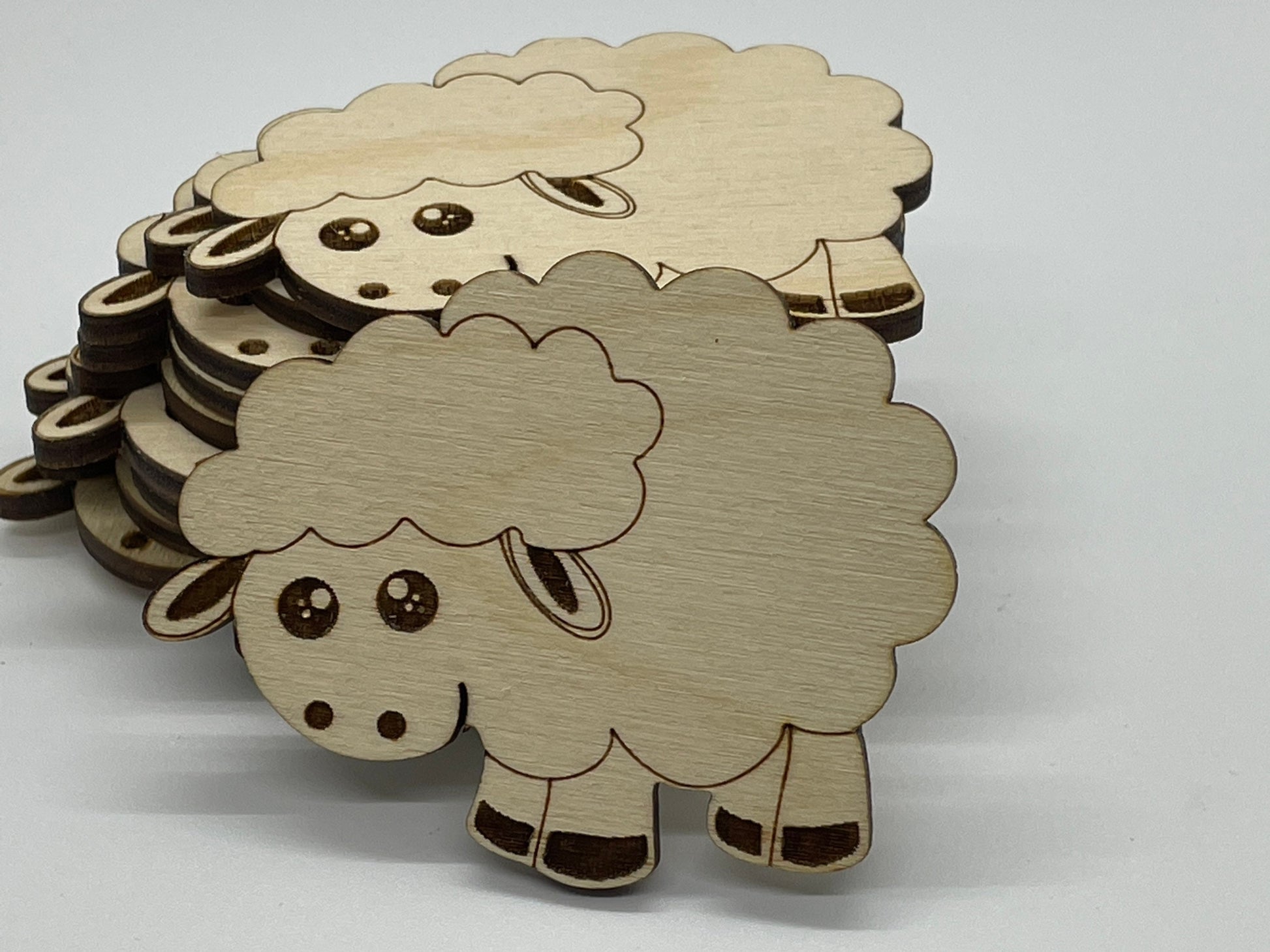 Wooden sheep cutouts on a white background