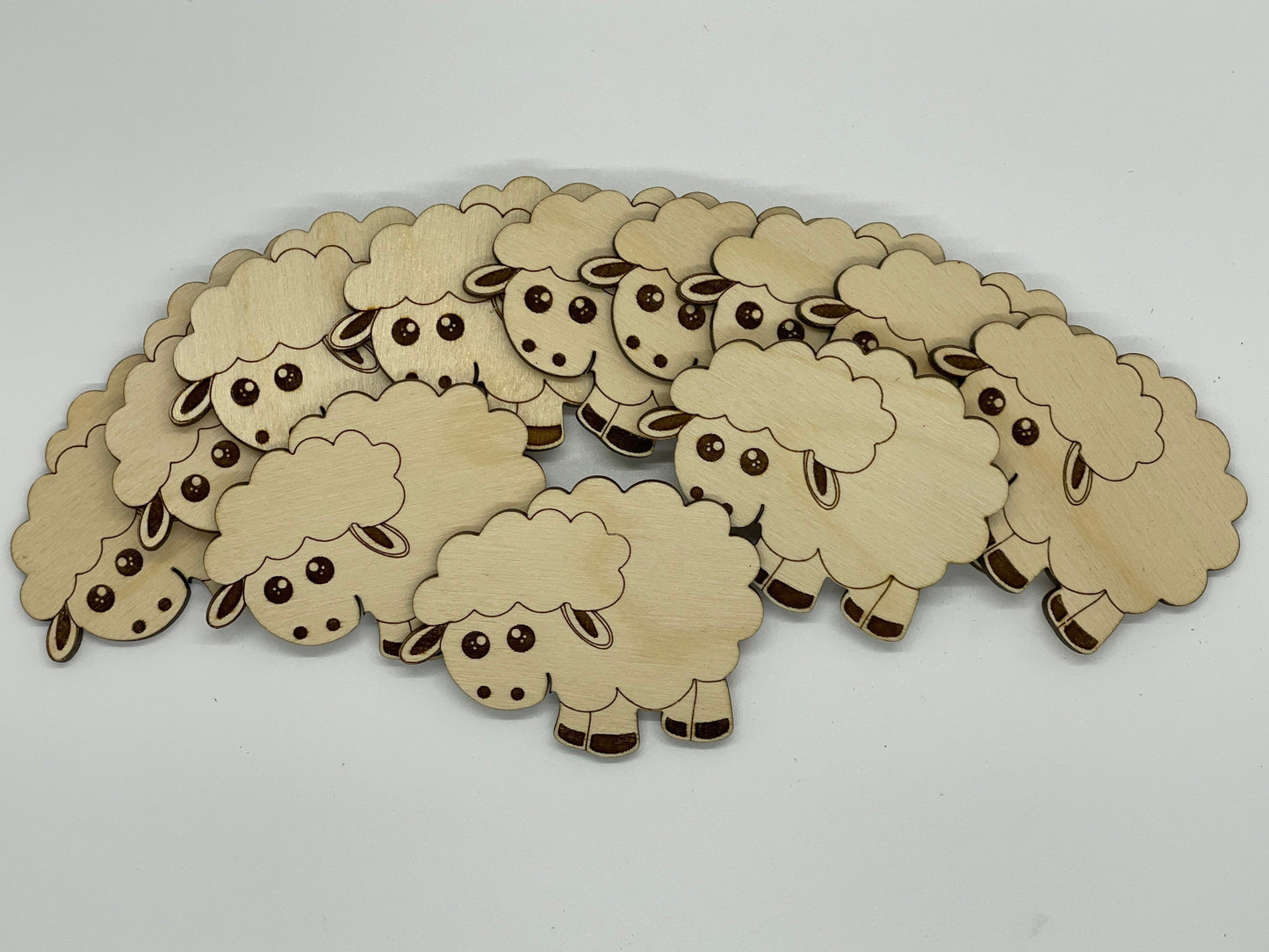 Wooden sheep cutouts on a white background