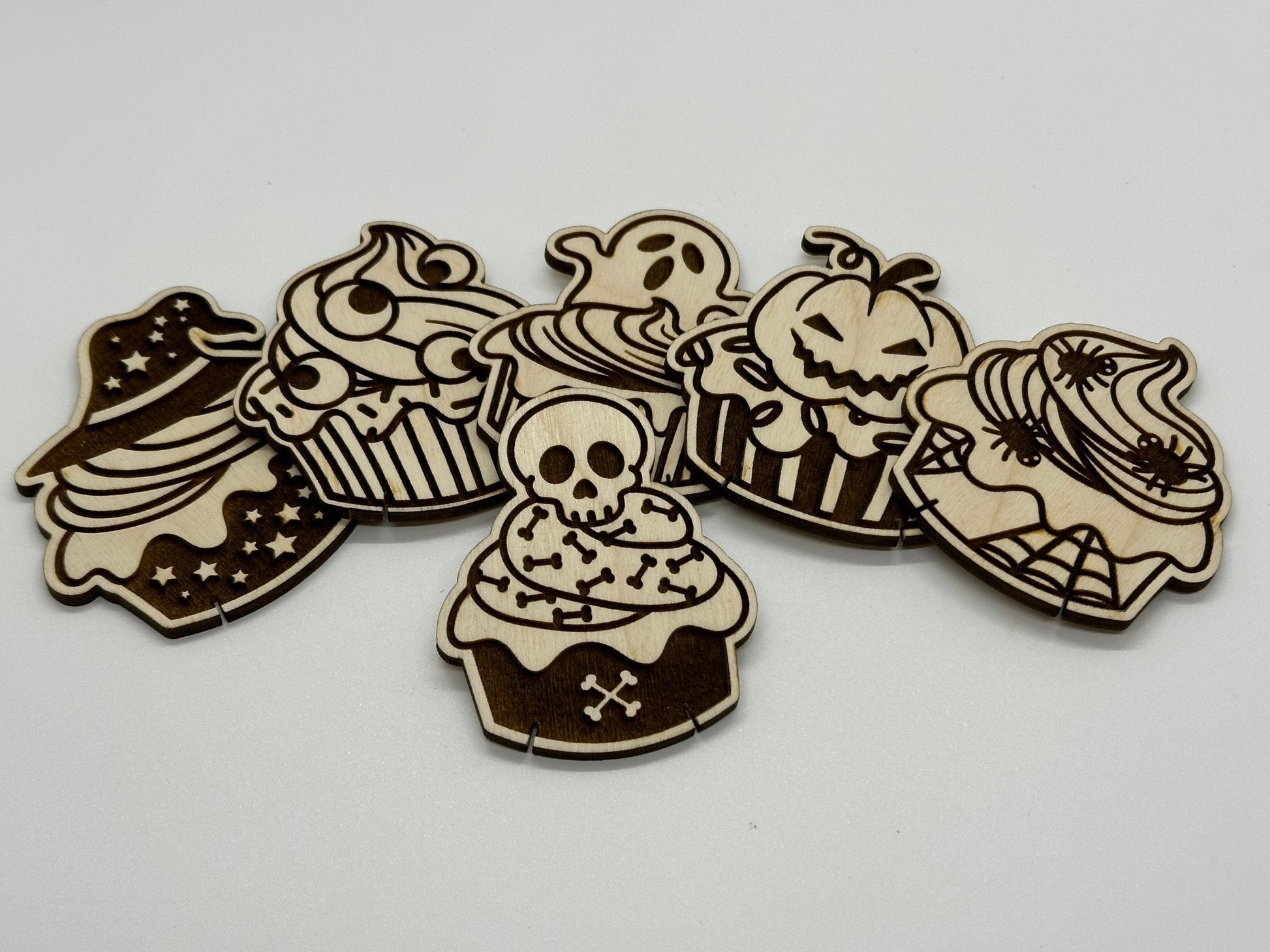 Set of Halloween-themed cupcake cutouts on a white background