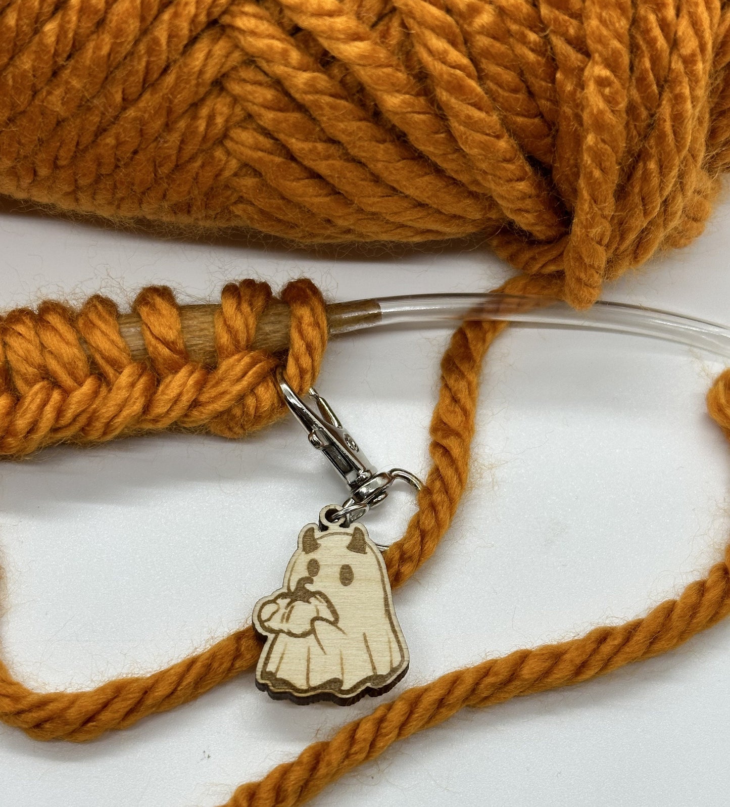 Yarn with a wooden charm on a white background