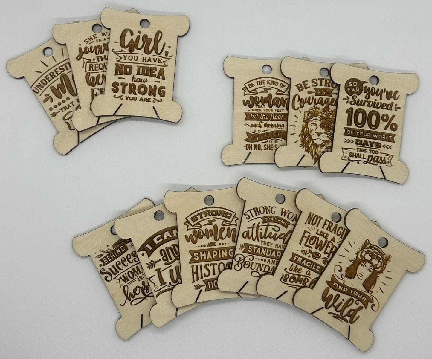 Wooden tags with motivational phrases on a light gray background