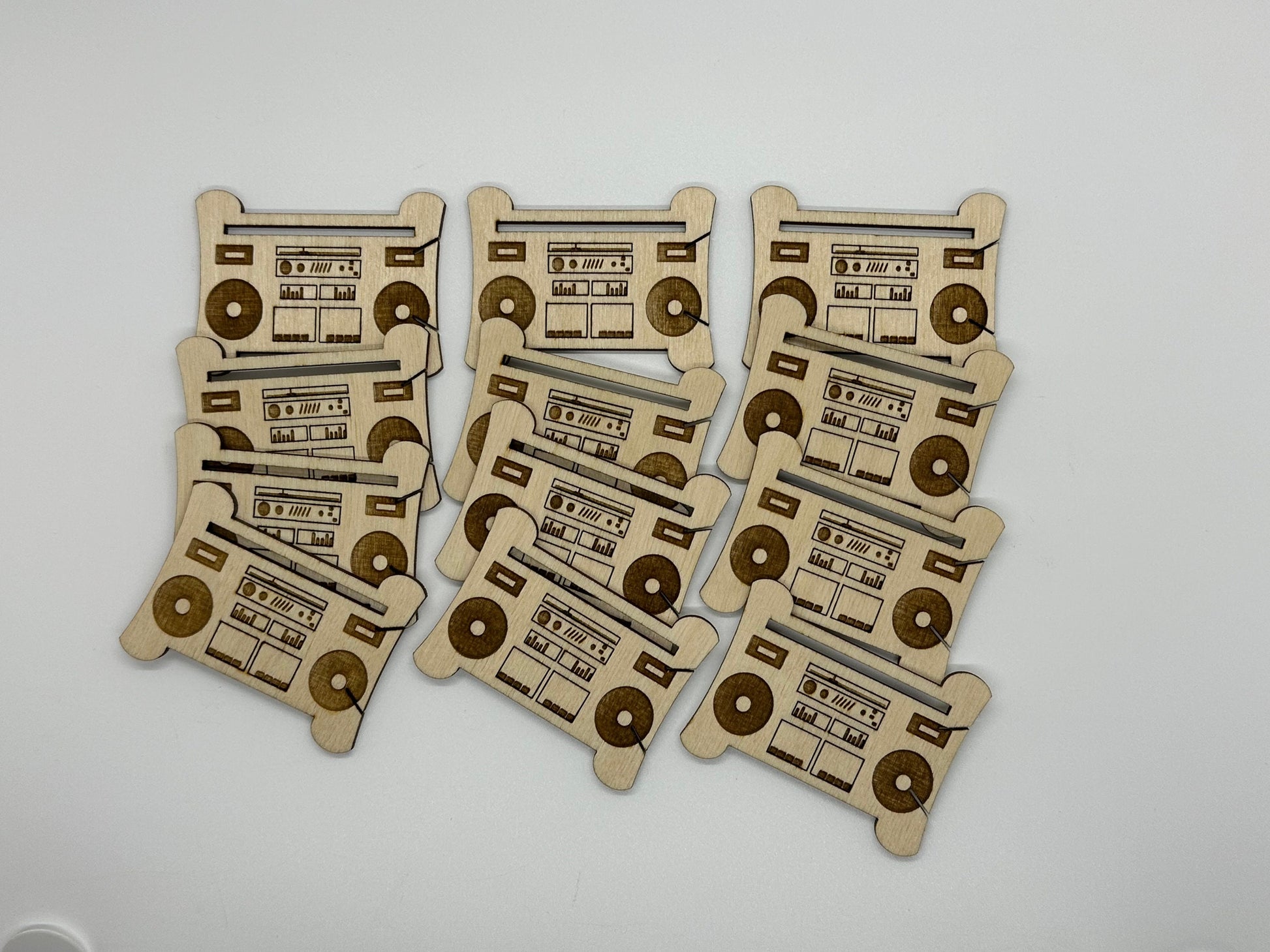 Set of wooden bobbins with radio and cassette design on a white background