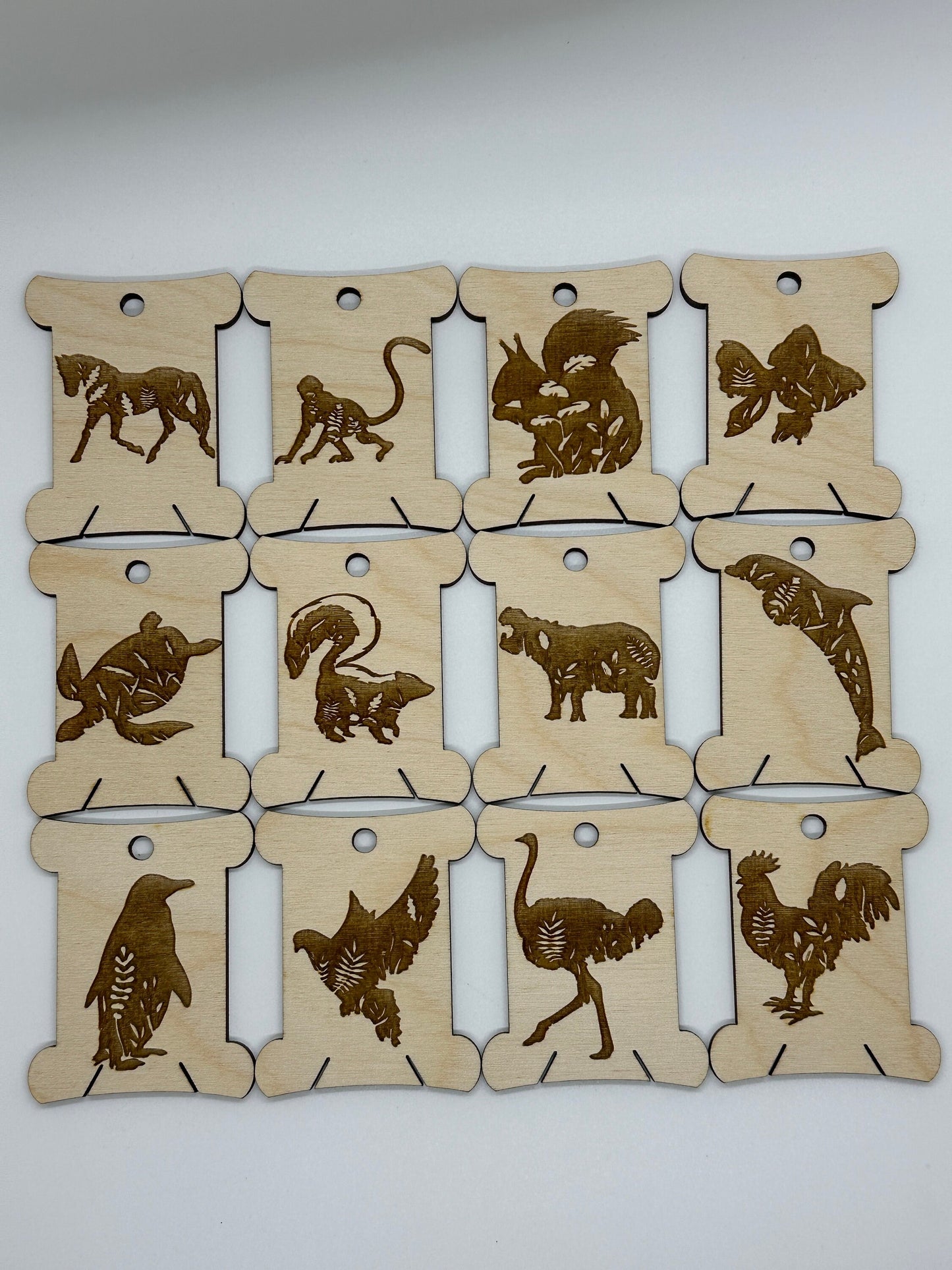 Set of wooden animal bobbins on a white background