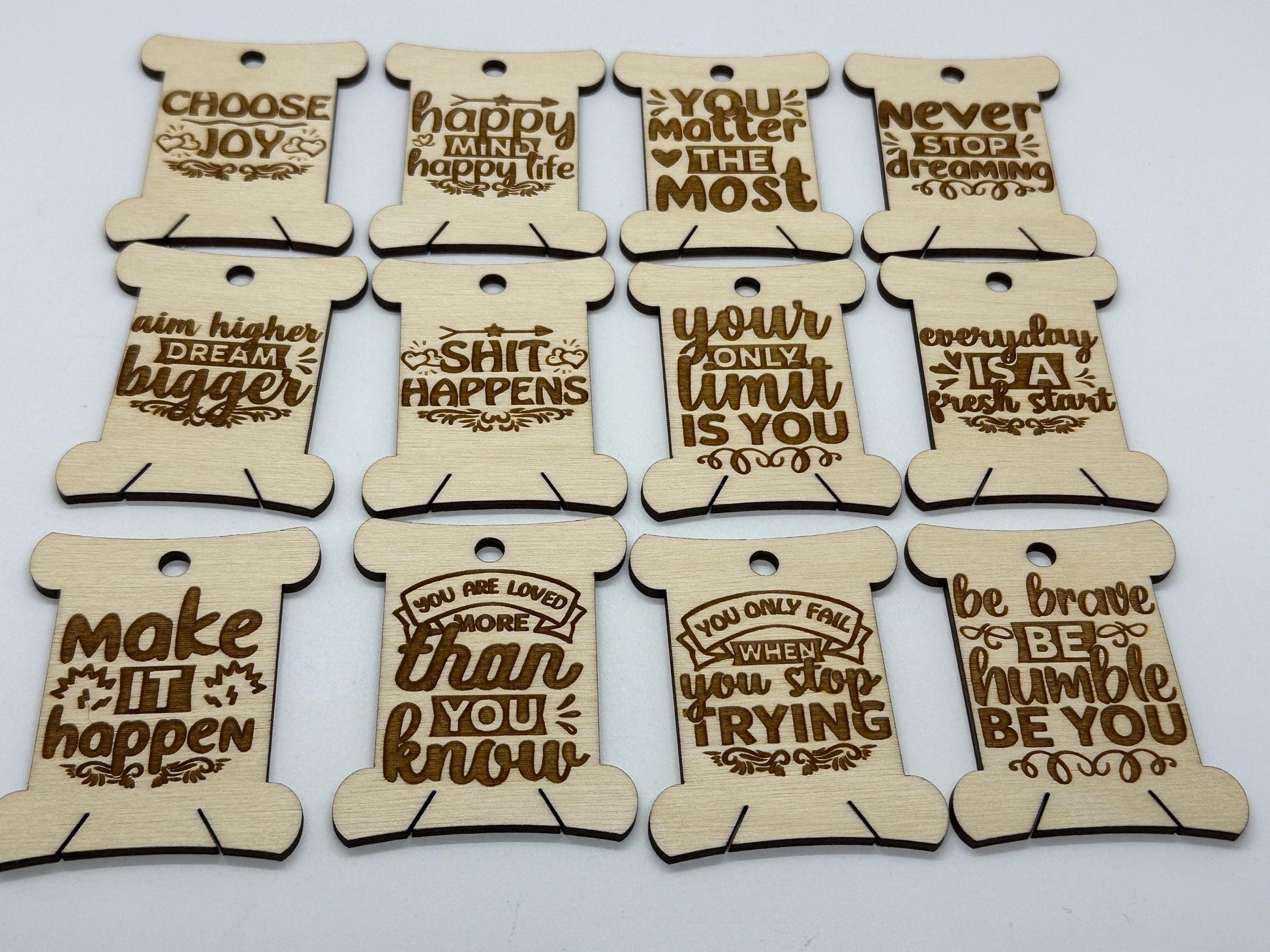 Set of wooden motivational tags with engraved quotes on a white background
