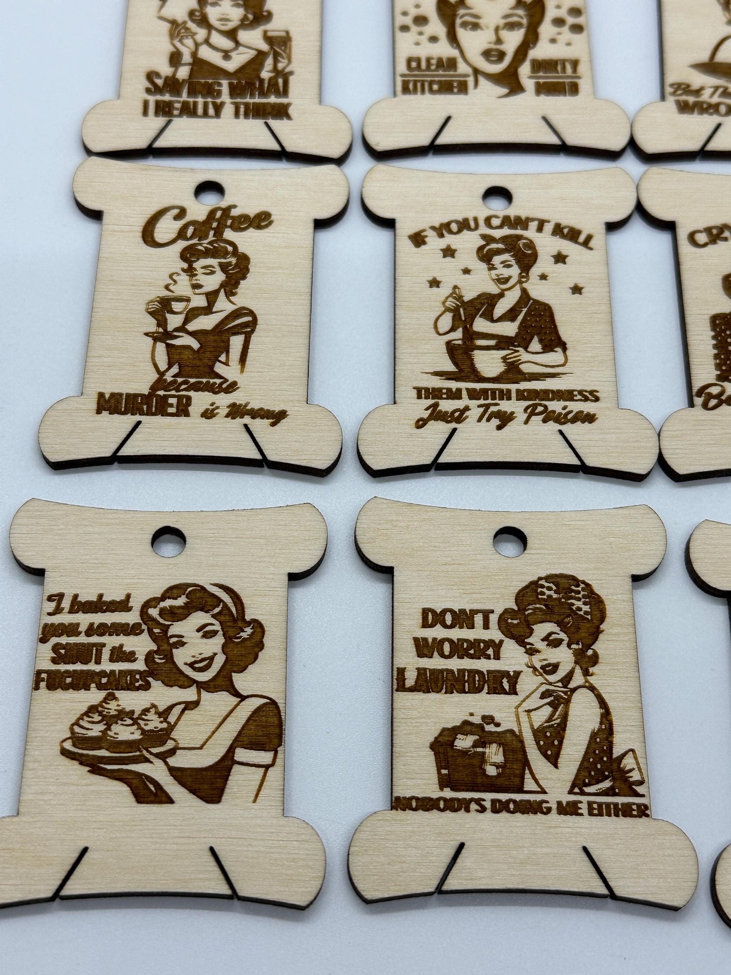 Wooden tags with humorous sayings and illustrations on a white background