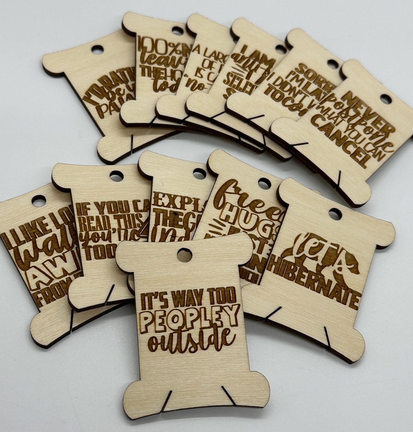 Wooden tags with humorous text on a white background