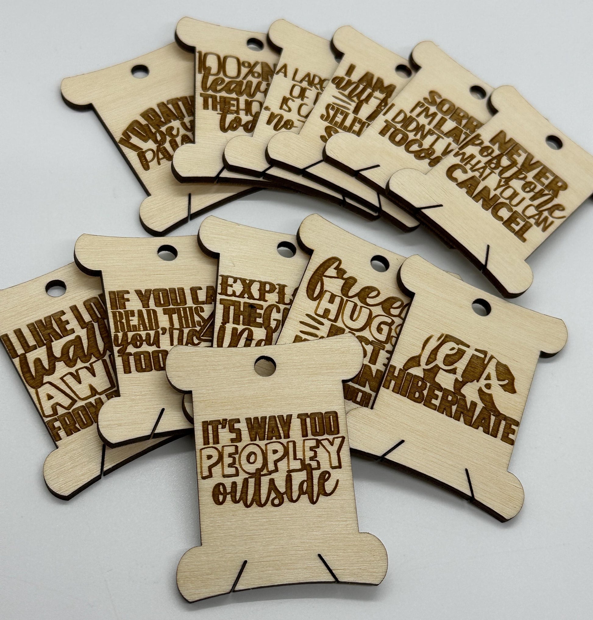 Wooden tags with humorous text on a white background