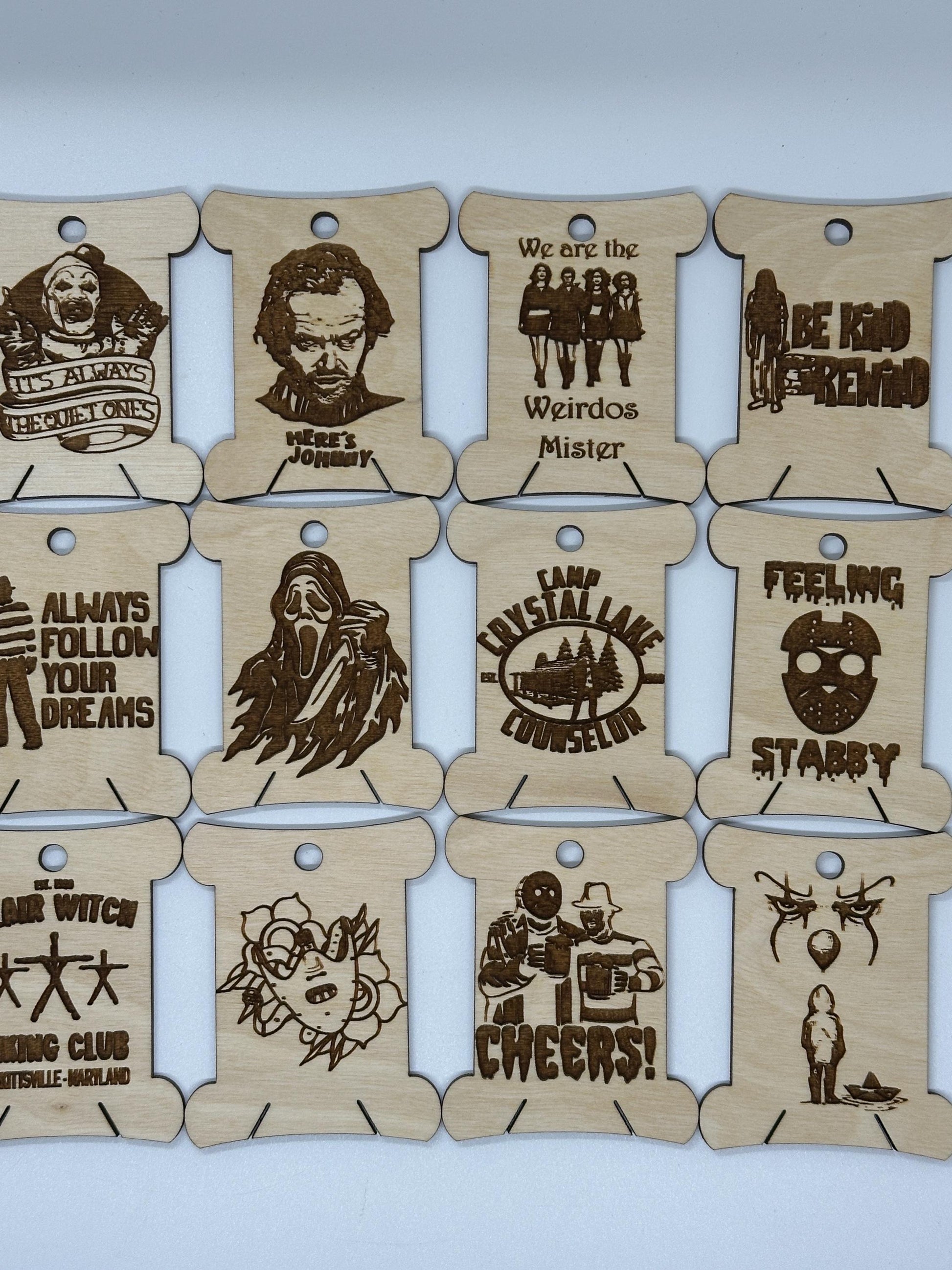 Set of wooden tags with laser-cut designs and text on a light blue background