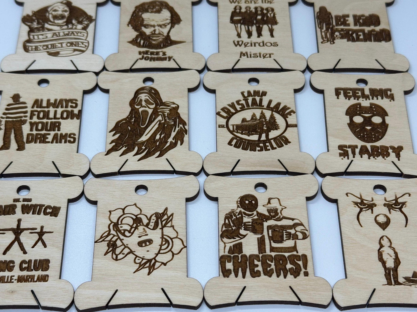 Set of wooden tags with laser-cut designs and text on a white background