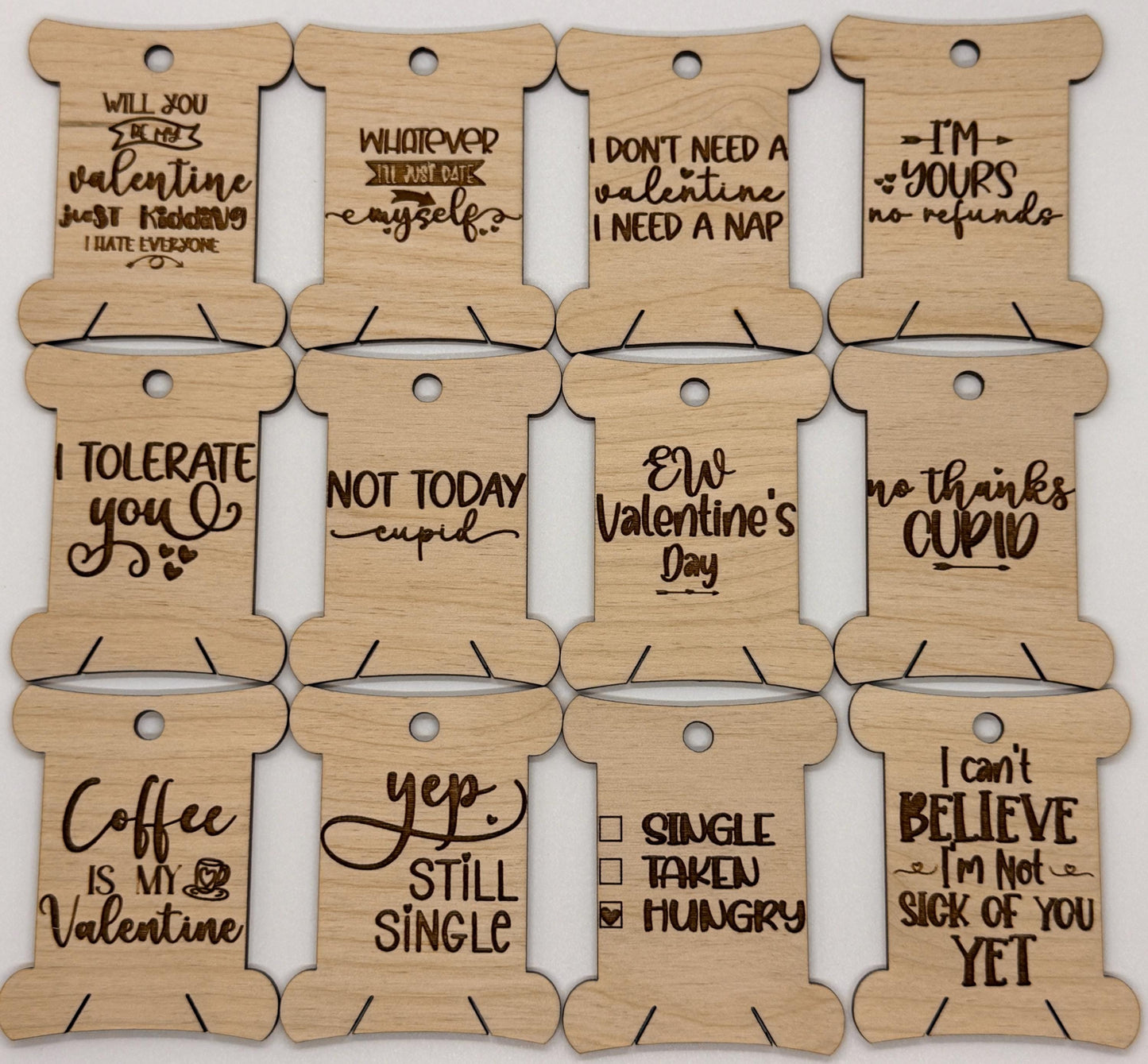 Wooden tags with humorous Valentine's Day sayings on a white background
