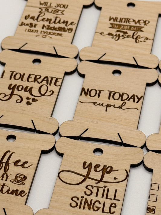Wooden tags with humorous sayings on a white background