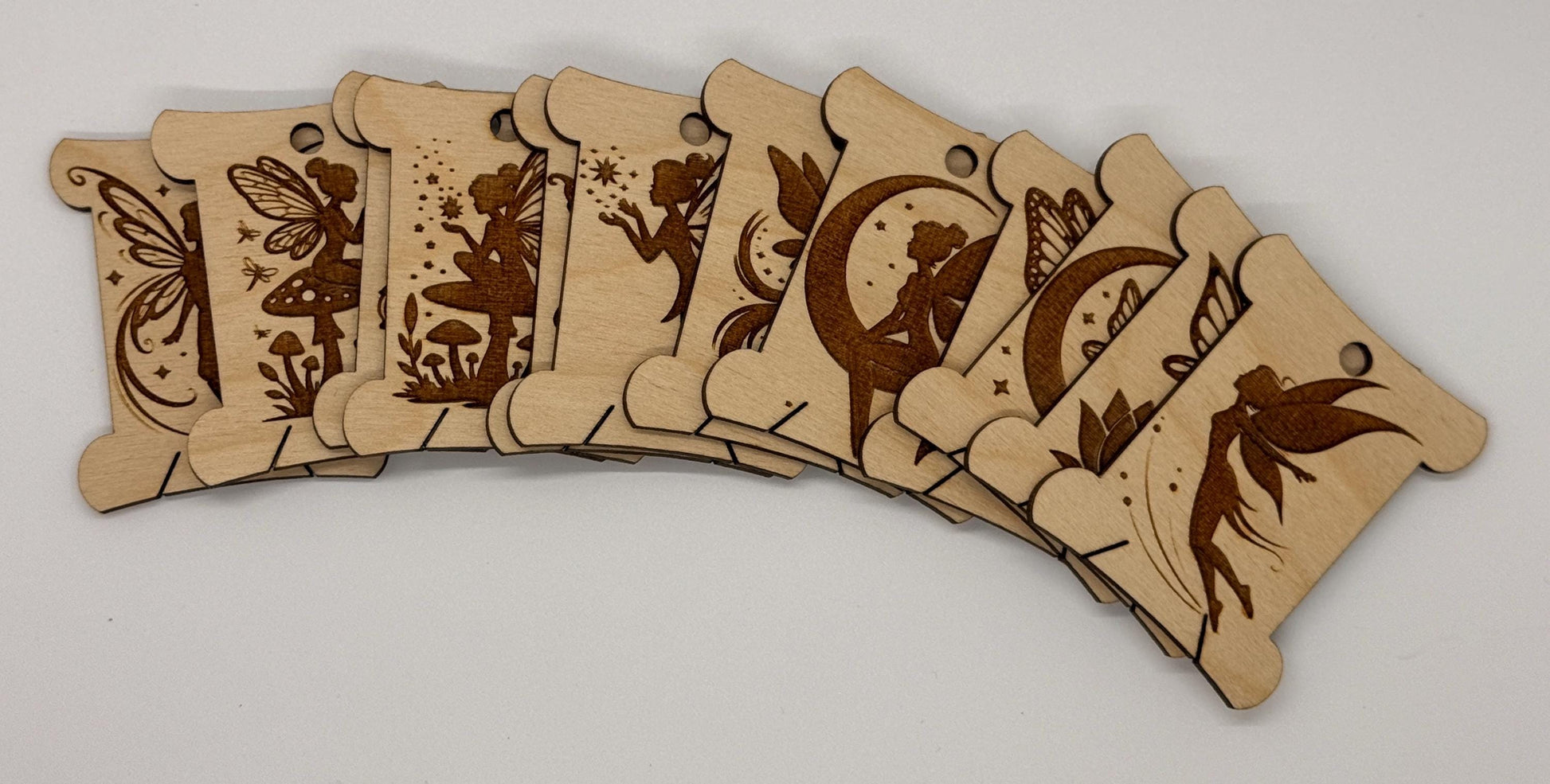 Set of wooden tags with fairy designs on a white background