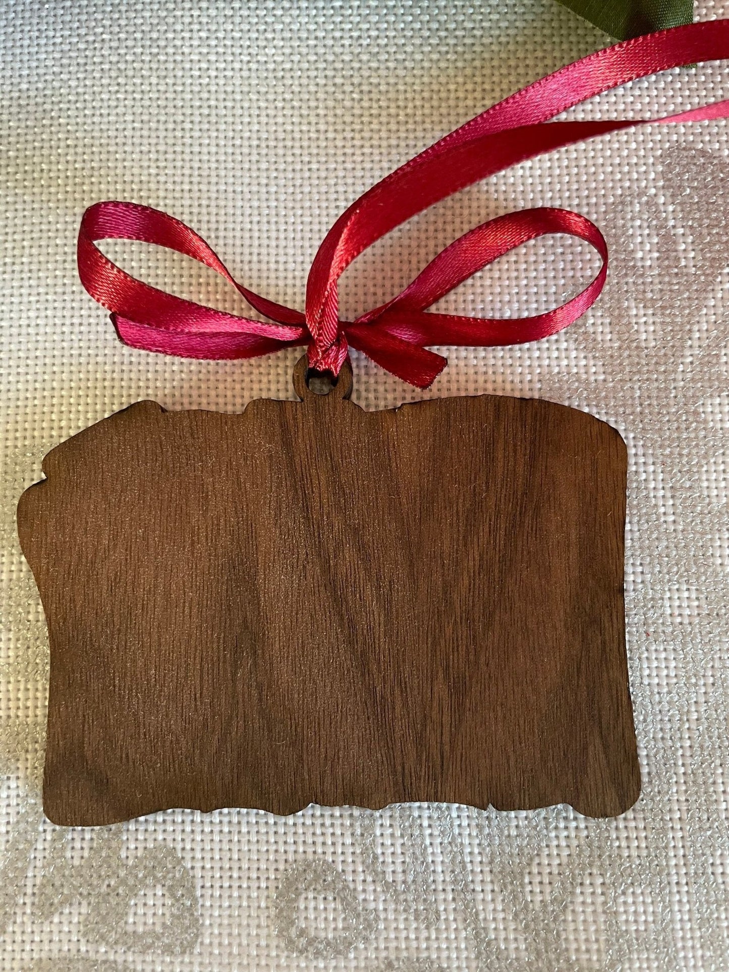 Laser engraved wooden I Solemnly Swear Christmas ornament on white background, scroll design on birch plywood